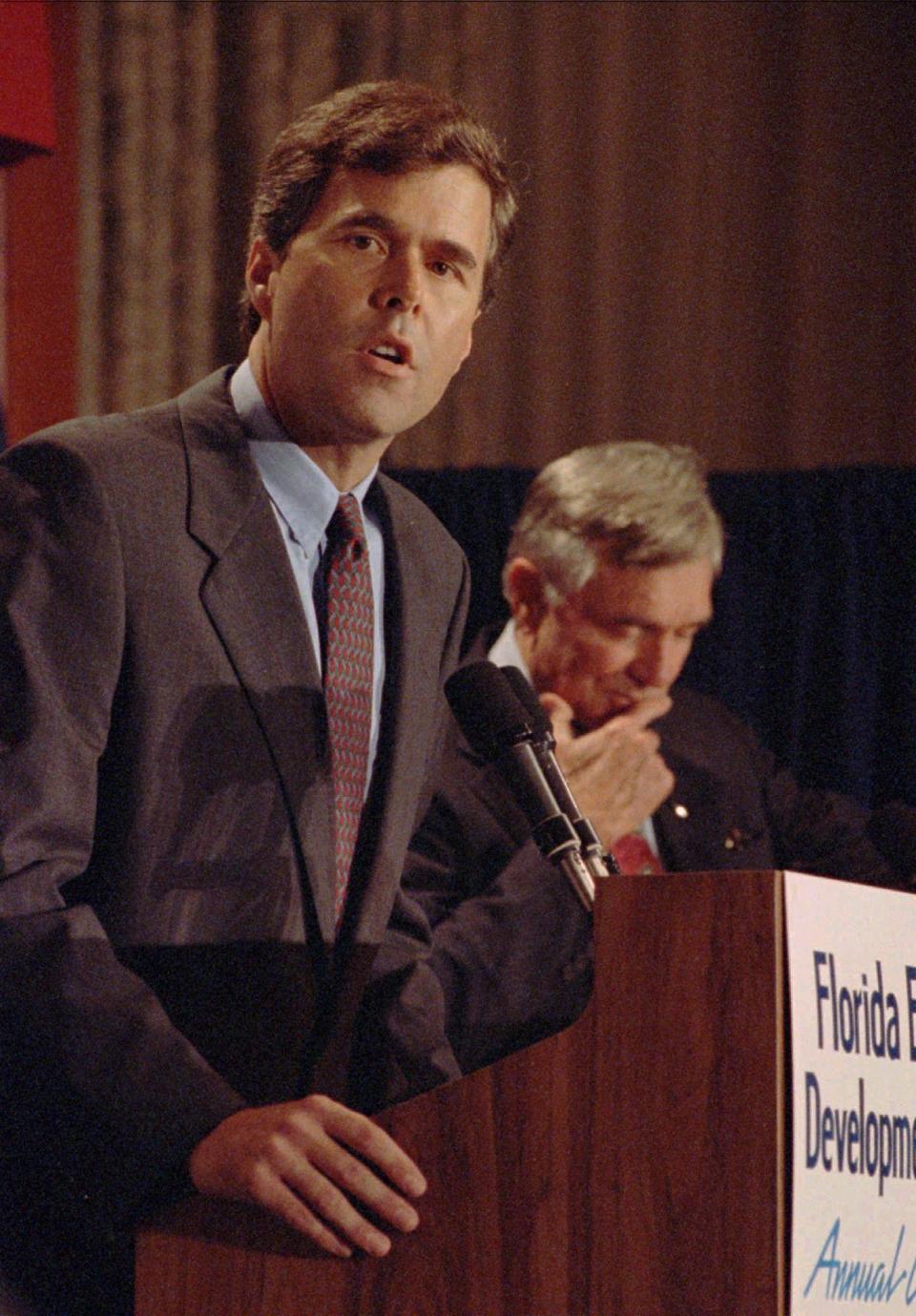 Florida gubernatorial candidate Jeb Bush answers questions as former governor Lawton Chiles listens during a debate in Miami on Sept. 29, 1994.