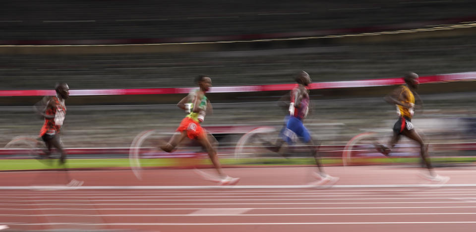 Jacob Kiplimo, of Uganda, right, leads the final of the men's 5,000-meters at the 2020 Summer Olympics, Friday, Aug. 6, 2021, in Tokyo, Japan. (AP Photo/Charlie Riedel)