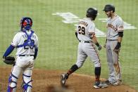 Texas Rangers catcher Jose Trevino (23) stands at the plate as San Francisco Giants' Mike Tauchman (29) and Steven Duggar, right, celebrate Tauchman's grand slam in the eighth inning of a baseball game in Arlington, Texas, Tuesday, June 8, 2021. (AP Photo/Tony Gutierrez)