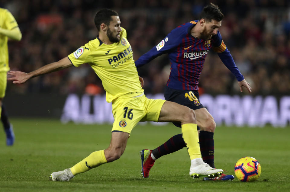 FC Barcelona's Lionel Messi, right, duels for the ball with Villarreal's Santiago Pedraza during the Spanish La Liga soccer match between FC Barcelona and Villarreal at the Camp Nou stadium in Barcelona, Spain, Sunday, Dec. 2, 2018. (AP Photo/Manu Fernandez)