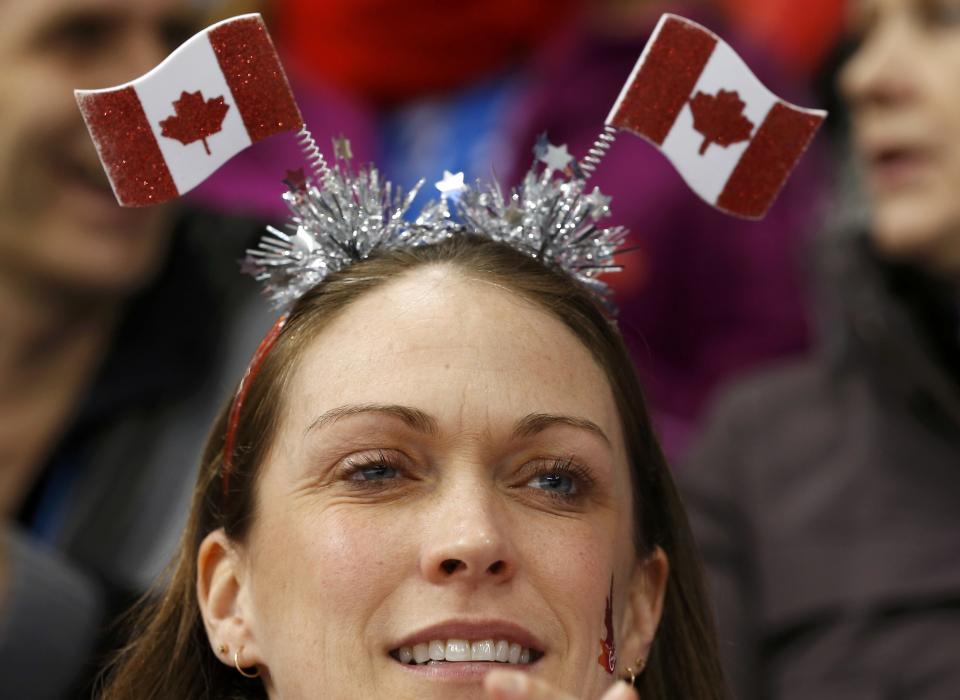 A fan of the Canadian team watches the women's ice hockey game against Switzerland at the 2014 Sochi Winter Olympics