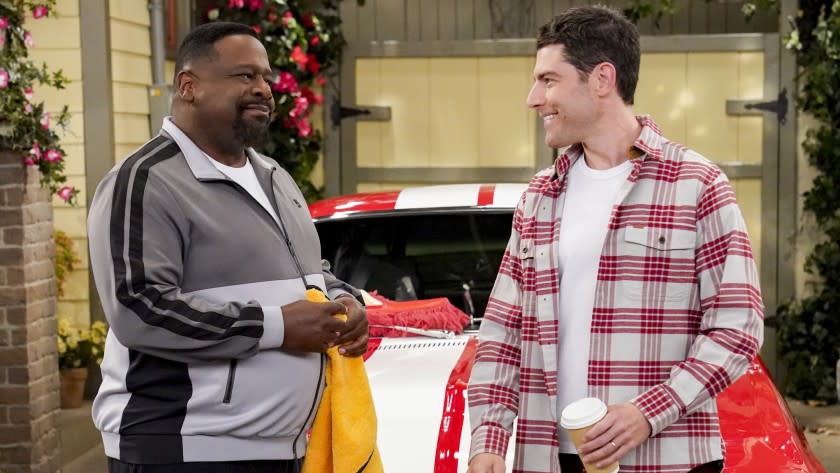 The Neighborhood -- CBS TV Series, "Welcome to the Road Trip" - Pictured: Cedric the Entertainer (Calvin Butler) and Max Greenfield (Dave Johnson). Calvin and Dave embark on their first road trip together to a classic car show, only to hit an unexpected roadblock that tests their friendship. Also, while their husbands are away, Tina and Gemma decide to take home repairs at the Butlers' into their own hands, on THE NEIGHBORHOOD, Monday, Dec. 14 (8:00-8:30 PM, ET/PT) on the CBS Television Network. Photo: Monty Brinton/CBS ©2020 CBS Broadcasting, Inc. All Rights Reserved. Cedric the Entertainer, left, and Max Greenfield in "The Neighborhood" on CBS.