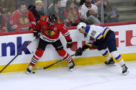 Chicago Blackhawks center Jonathan Toews, left, battles for the puck against St. Louis Blues center Jordan Kyrou during the second period of an NHL hockey game in Chicago, Friday, Nov. 26, 2021. (AP Photo/Nam Y. Huh)