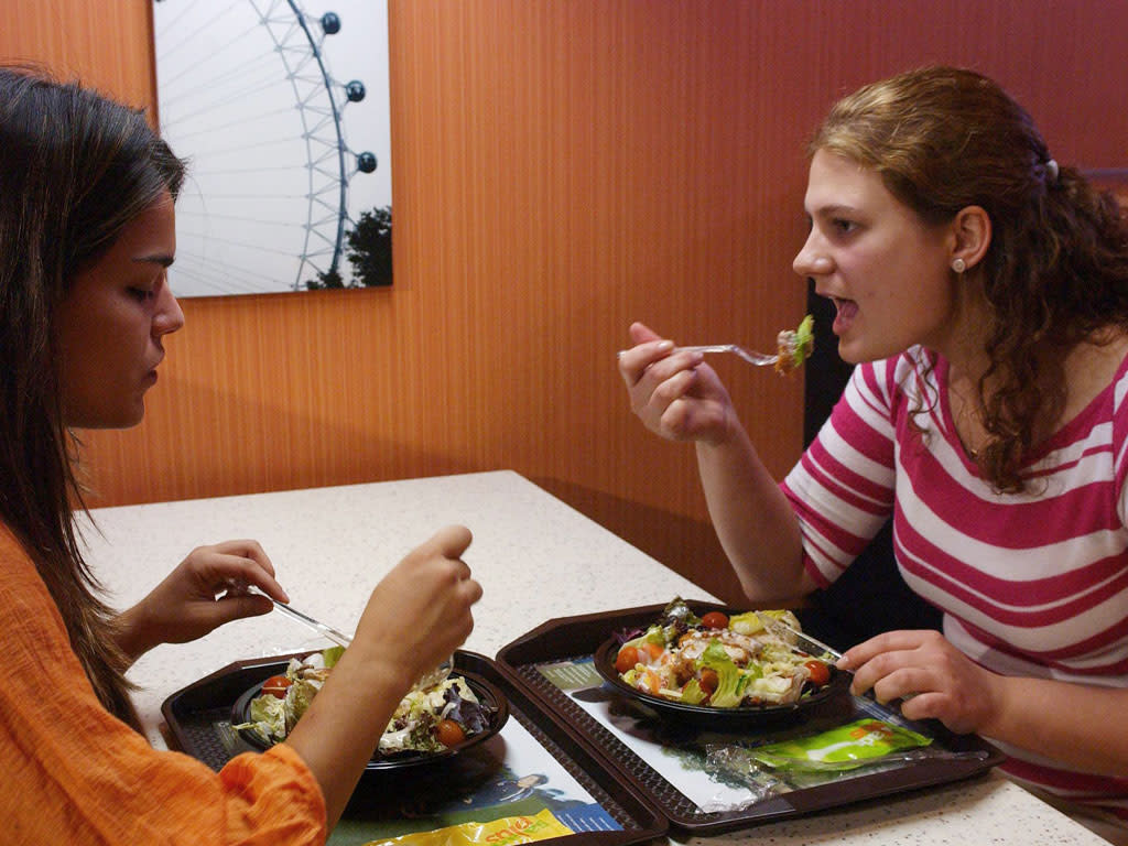 Two customers eat salads at a McDonalds in central