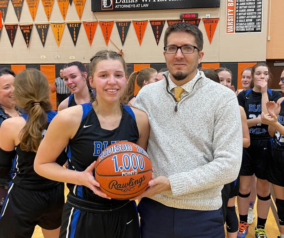 Cambridge Springs basketball player Madison Yanc, left, scored her 1,000th career point on Friday in her final high school game. Here she poses with coach Ryan McKissock after the Blue Devils lost to Neshannock 44-25 in the PIAA Class 2A second round at Sharon High School.