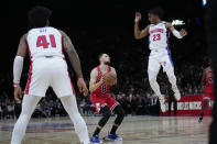 Detroit Pistons Jaden Ivey, right, jumps to block as Chicago Bulls Zach LaVine, centre, prepares to shoot during the NBA basketball game between Chicago Bulls and Detroit Pistons at the Accor Arena in Paris, Thursday, Jan. 19, 2023. (AP Photo/Christophe Ena)