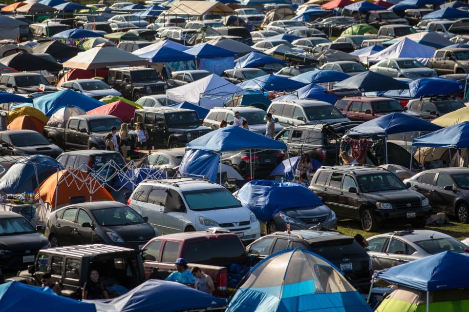 Tents are packed in as people set up camp.