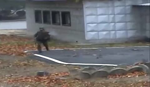 A North Korea soldier runs across the military demarcation line (MDL) while in pursuit of a defector  - Credit: AFP