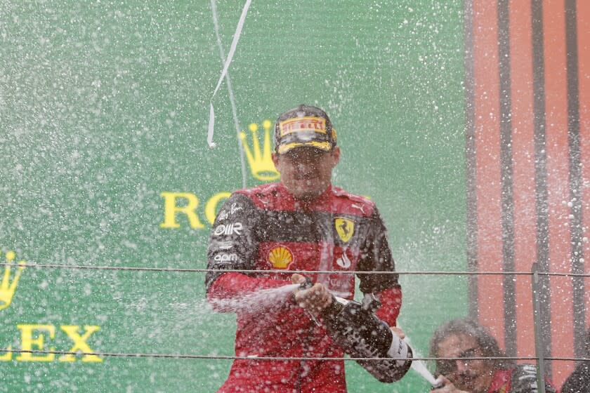 Ferrari driver Charles Leclerc of Monaco celebrates on the podium after winning the Austrian F1 Grand Prix at the Red Bull Ring racetrack in Spielberg, Austria, Sunday, July 10, 2022. (AP Photo/Matthias Schrader)