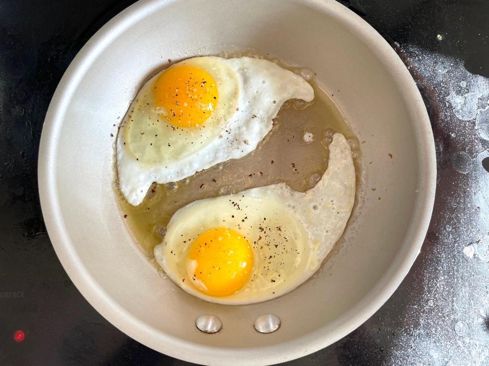 Frying eggs for Ina Garten's avocado tartine