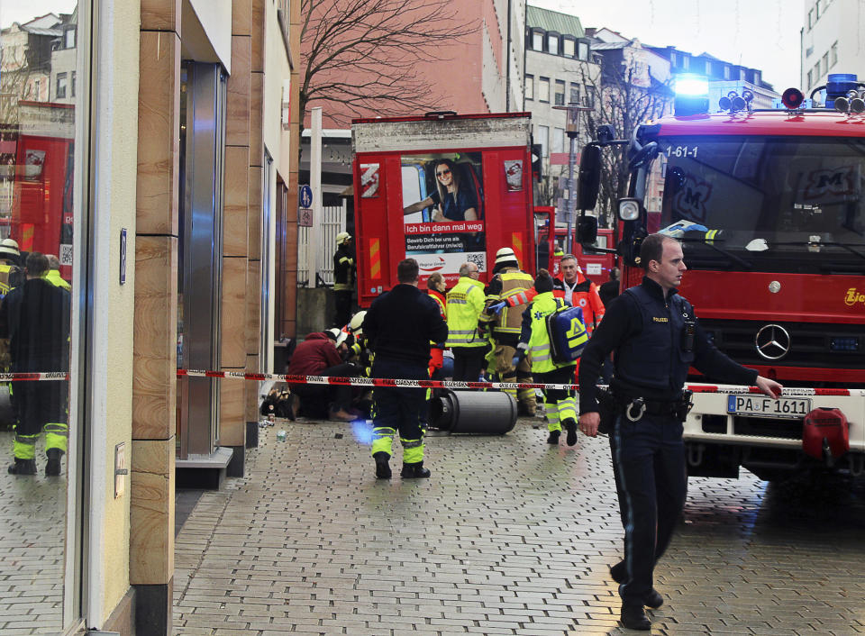 Fire and rescue services stand at the scene of a car accident in the city center in Passau, Germany, Friday Dec. 29, 2023. A deadly truck crash in southern Germany on Friday left one person dead, German police said. The 63-year old truck driver continued his ride after making a delivery in downtown Passau close to the city’s railway station, passed by a parked vehicle and then hit a group of five people. (Zema Medien/dpa via AP)