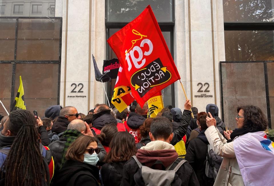 French SNCF workers, members of French CGT and Sud Rail labour unions enter the headquarters of luxury retailer Louis Vuitton during a demonstration in Paris as part of the 12th day of nationwide strikes  (REUTERS)