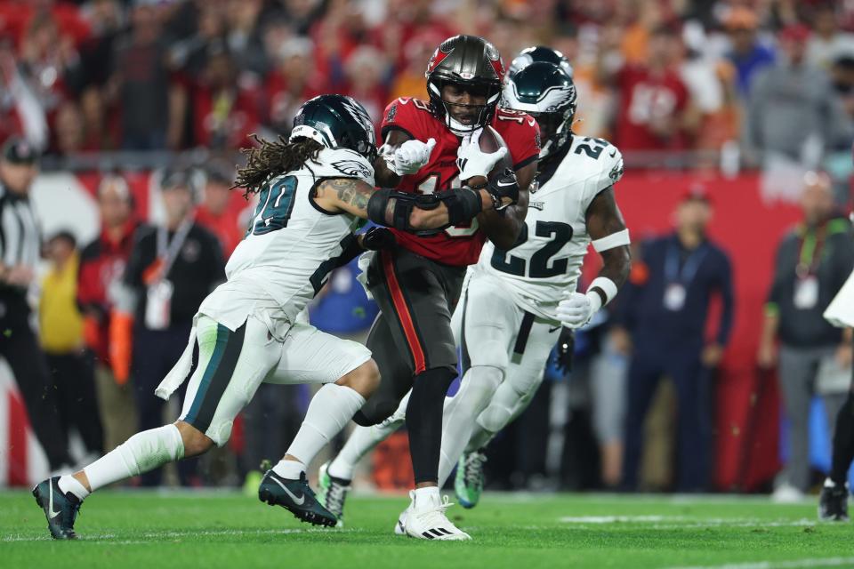 Jan 15, 2024; Tampa, Florida, USA; Tampa Bay Buccaneers wide receiver David Moore (19) runs the ball for a touchdown after a reception as Philadelphia Eagles cornerbacks <a class="link " href="https://sports.yahoo.com/nfl/players/31095" data-i13n="sec:content-canvas;subsec:anchor_text;elm:context_link" data-ylk="slk:Avonte Maddox;sec:content-canvas;subsec:anchor_text;elm:context_link;itc:0">Avonte Maddox</a> (29) and <a class="link " href="https://sports.yahoo.com/nfl/players/40131" data-i13n="sec:content-canvas;subsec:anchor_text;elm:context_link" data-ylk="slk:Kelee Ringo;sec:content-canvas;subsec:anchor_text;elm:context_link;itc:0">Kelee Ringo</a> (22) attempt to tackle during the first half of a 2024 NFC wild card game at Raymond James Stadium. Mandatory Credit: Nathan Ray Seebeck-USA TODAY Sports