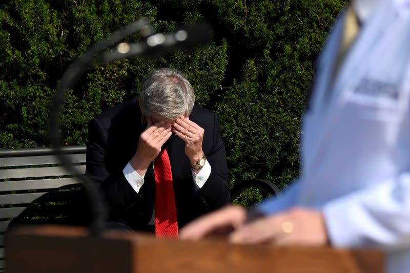 FILE PHOTO: White House Chief of Staff Mark Meadows rubs his head as U.S. Navy Commander Dr. Sean Conley speaks about U.S. President Donald Trump's health, in Bethesda