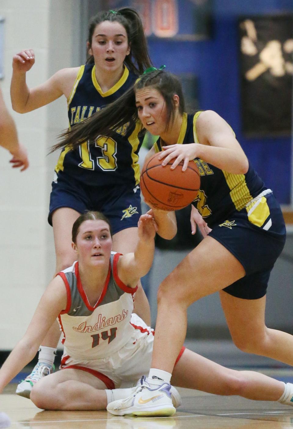 Northwest's Delanie Carmany reaches for the ball as Tallmadge's Lexi Gray looks to pass and Sydney Becks looks on during a Division II girls basketball district semifinal on Feb. 22, 2023, at Lake High School.