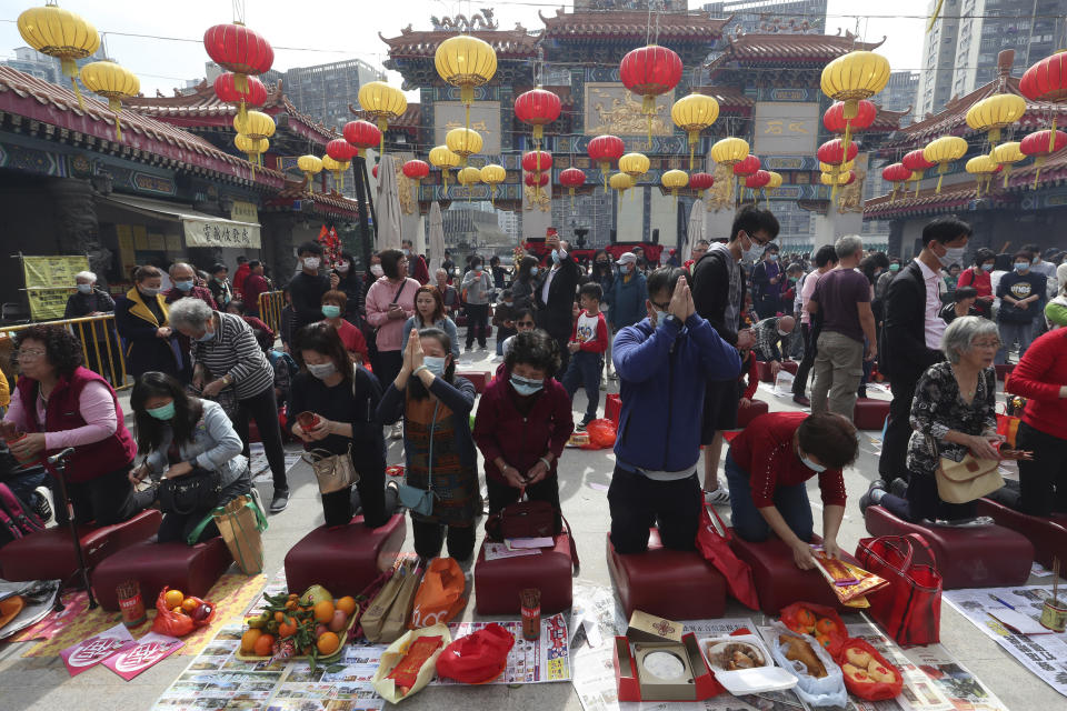 People pray at the Wong Tai Sin Temple, in Hong Kong, Saturday, Jan. 25, 2020 to celebrate the Lunar New Year which marks the Year of the Rat in the Chinese zodiac. China's most festive holiday began in the shadow of a worrying new virus Saturday as the death toll surpassed 40, an unprecedented lockdown kept 36 million people from traveling and authorities canceled a host of Lunar New Year events. (AP Photo/Achmad Ibrahim)