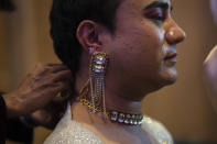 A contestant gets ready for the Miss Trans Northeast 22, beauty pageant in Guwahati, India, Wednesday, Nov. 30, 2022. In a celebration of gender diversity and creative expression, a beauty pageant in eastern Indian state of Assam brought dozens of transgender models on stage in Guwahati. Sexual minorities across India have gained a degree of acceptance especially in big cities and transgender people were given equal rights as a third gender in 2014. But prejudice against them persists and the community continues to face discrimination and rejection by their families. (AP Photo/Anupam Nath)