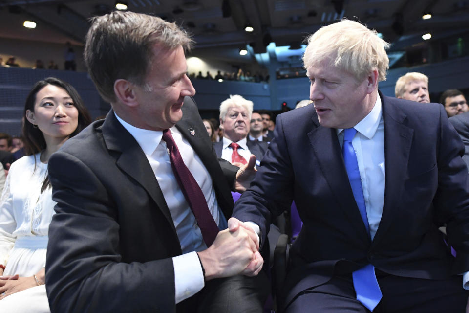 Jeremy Hunt, left, congratulates Boris Johnson after the announcement of the result in the ballot for the new Conservative party leader, in London, Tuesday, July 23, 2019. Brexit hardliner Boris Johnson won the contest to lead Britain's governing Conservative Party on Tuesday and will become the country's next prime minister, tasked with fulfilling his promise to lead the U.K. out of the European Union "come what may." (Stefan Rousseau/Pool photo via AP)