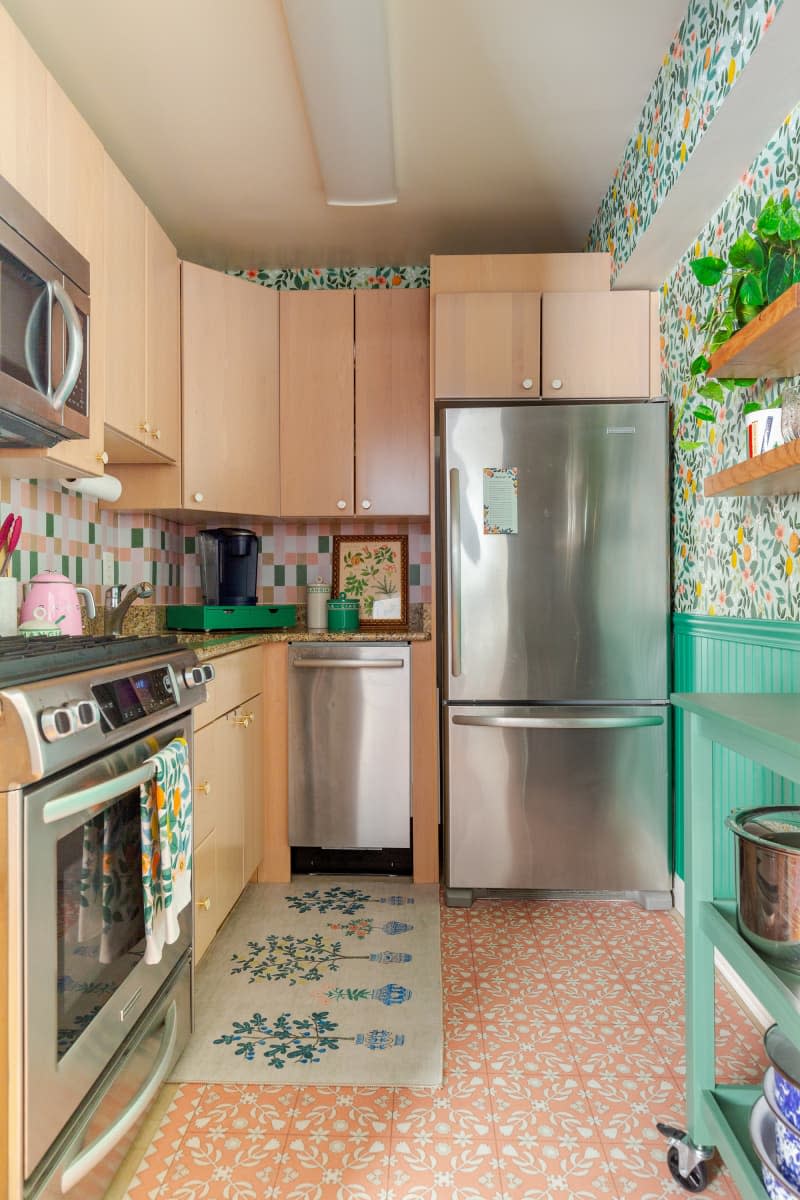 A kitchen with stainless steel appliances and light wood cabinets.