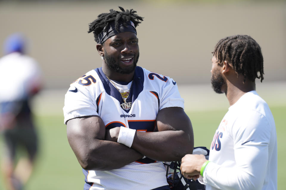 Denver Broncos running back Melvin Gordon, left, talks with wide receiver Diontae Spencer after an NFL football training camp at the team's headquarters Thursday, Aug. 19, 2021, in Englewood, Colo. (AP Photo/David Zalubowski)