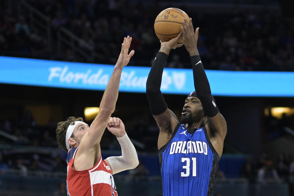 Orlando Magic guard Terrence Ross (31) shoots in front of Washington Wizards forward Corey Kispert (24) during the first half of an NBA basketball game Friday, Dec. 30, 2022, in Orlando, Fla. (AP Photo/Phelan M. Ebenhack)