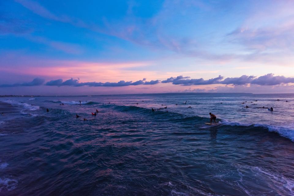 Surfing at Batu Bolong Beach in Canggu, Bali, Indonesia