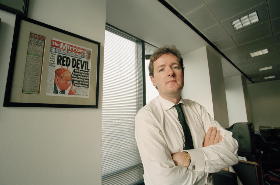 Daily Mirror editor Piers Morgan in his office at Canary Wharf, London, 14th December 1998. On the left is a framed front page attack on rival newspaper proprietor Rupert Murdoch. (Photo by Peter Macdiarmid/Getty Images)