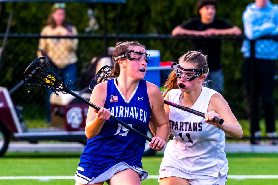 Fairhaven's Sydney Burke drives around Bishop Stang's Isabella Bromage.