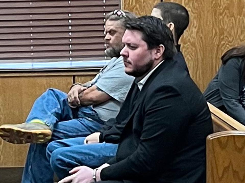 Christopher Jarvis, in suit, sits handcuffed in 30th District Court Friday awaiting transfer to the Wichita County Jail.