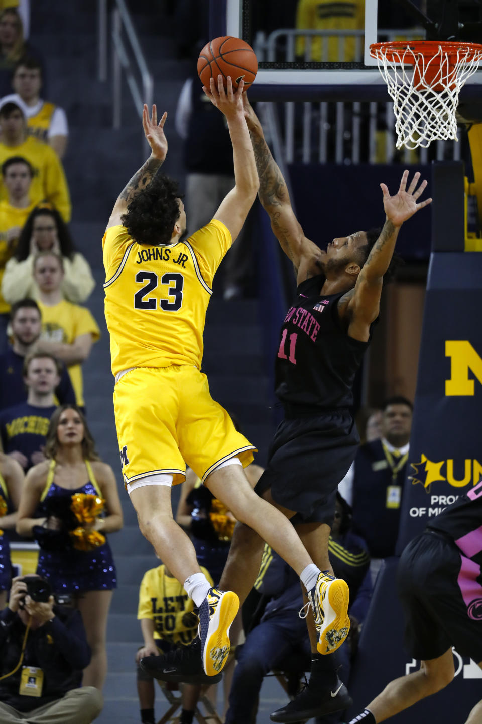 Michigan forward Brandon Johns Jr. (23) drives on Penn State forward Lamar Stevens (11) in the first half of an NCAA college basketball game in Ann Arbor, Mich., Wednesday, Jan. 22, 2020. (AP Photo/Paul Sancya)