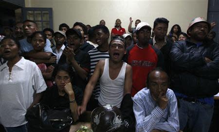 People react as votes are counted at a polling centre in the capital Antananarivo, October 25, 2013. REUTERS/Thomas Mukoya