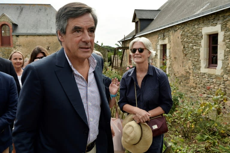 Former French Prime Minister Francois Fillon (L) and his wife Penelope Fillon, who is accused of barely working for a government salary, are seen in 2015