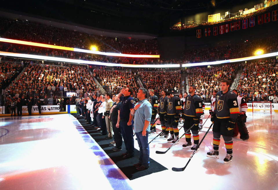 <p>Members of the medical and law enforcement communities accompany the players onto the ice during player introductions. (Bruce Bennett/Getty Images) </p>