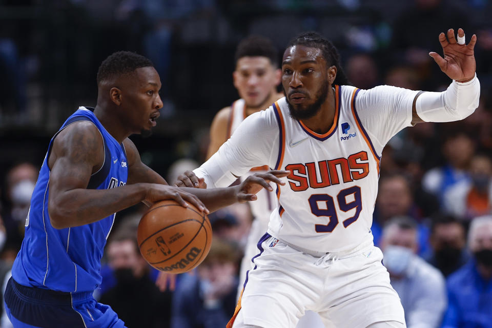 Dallas Mavericks forward Dorian Finney-Smith, left, battles Phoenix Suns forward Jae Crowder (99) for space during the first half of an NBA basketball game, Thursday, Jan. 20, 2022, in Dallas. (AP Photo/Brandon Wade)