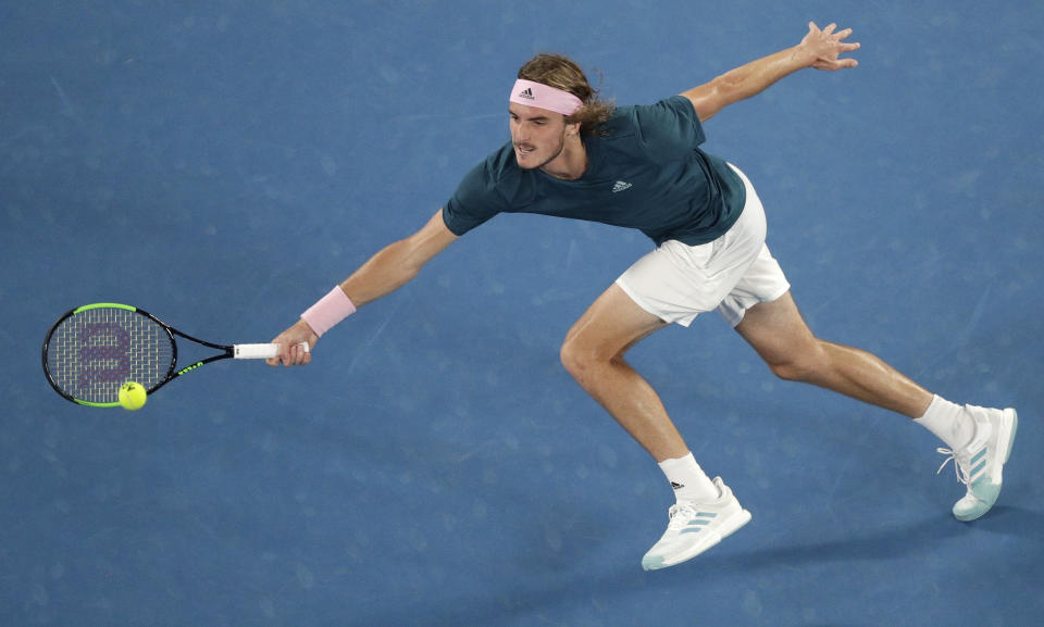 Greece's Stefanos Tsitsipas makes a forehand return to Spain's Rafael Nadal during their semifinal at the Australian Open tennis championships in Melbourne, Australia, Thursday, Jan. 24, 2019. (AP Photo/Kin Cheung)