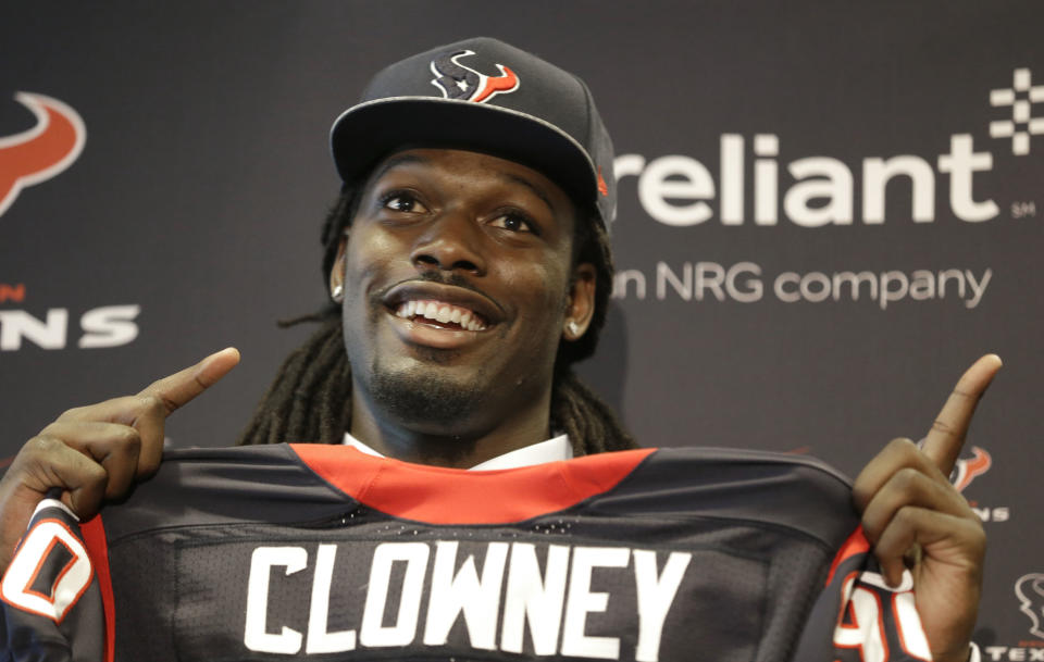 Jadeveon Clowney, the Houston Texans No. 1 overall draft pick, holds up his new jersey and jokes about where to look during an NFL football press conference Friday, May 9, 2014, in Houston. (AP Photo/Pat Sullivan)