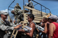 <p>Soldiers of Puerto Rico’s national guard distribute relief items to people, after the area was hit by Hurricane Maria in San Juan, Puerto Rico September 24, 2017. (Photo: Alvin Baez/Reuters) </p>