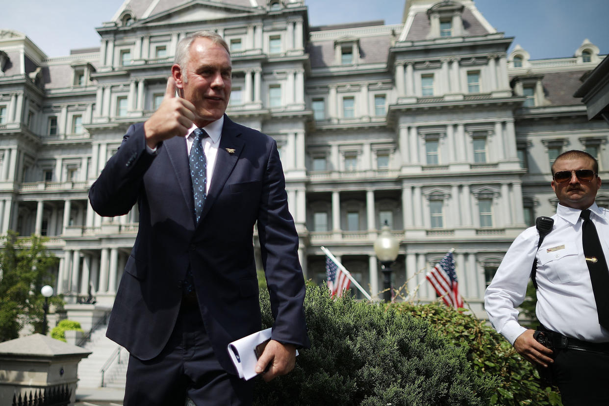 Interior Secretary Ryan Zinke talks to journalists outside the White House West Wing before attending a Cabinet meeting with President Donald Trump on Thursday. Zinke said the wildfires in the West are caused by mismanaged public lands and "environmental terrorist&nbsp;groups." (Photo: Chip Somodevilla via Getty Images)