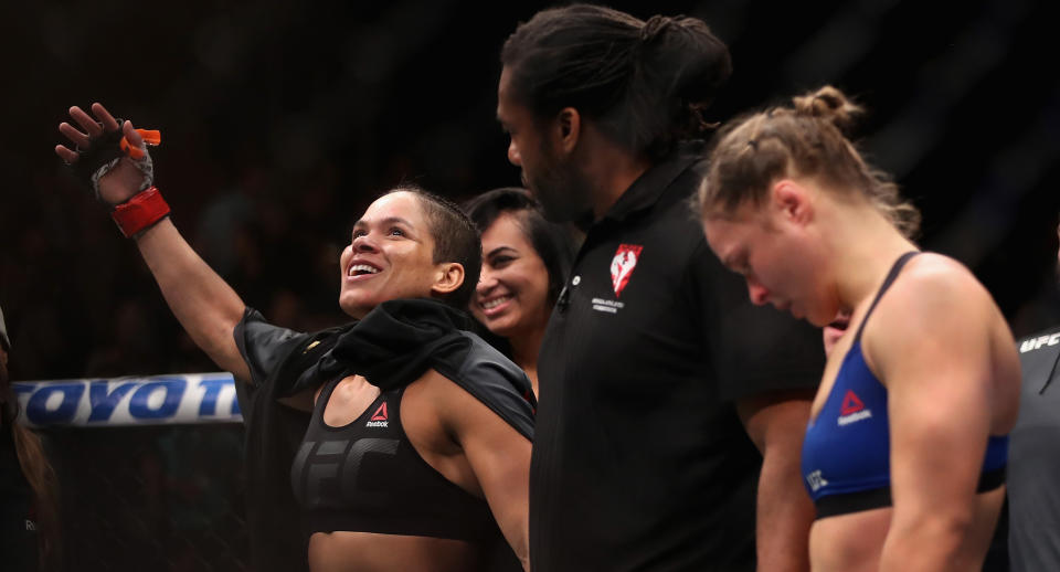 Amanda Nunes (L) of Brazil reacts after defeating Ronda Rousey in their UFC women’s bantamweight championship bout during the UFC 207 event at T-Mobile Arena on December 30, 2016 in Las Vegas, Nevada. (Getty Images)