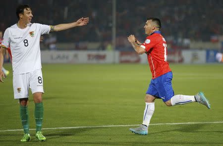 Chile's Gary Medel celebrates next to Bolivia's Martin Smedeberg after scoring a goal during their first round Copa America 2015 soccer match at the National Stadium in Santiago, Chile, June 19, 2015. REUTERS/Henry Romero