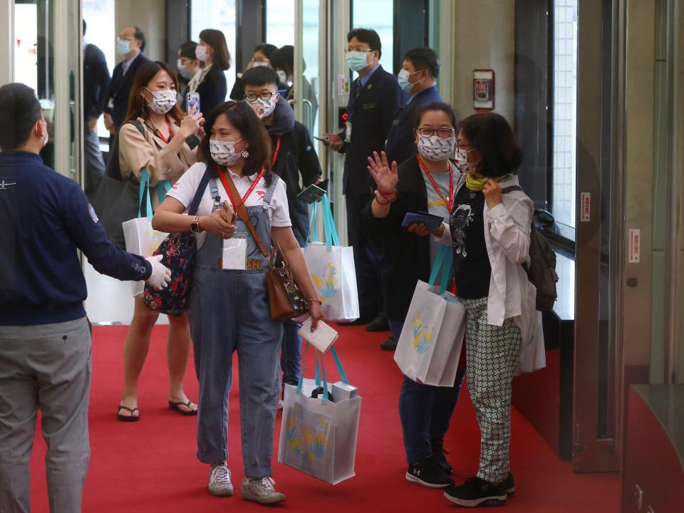 Travellers, wearing face masks following the coronavirus disease (COVID-19) outbreak, enter the boarding gate for the travel bubble flight to Palau, at Taoyuan International Airport in Taoyuan, Taiwan April 1, 2021.