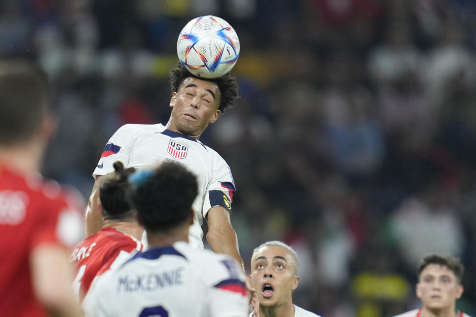 Tyler Adams of the United States heads the ball during the World Cup, group B soccer match between the United States and Wales, at the Ahmad Bin Ali Stadium in Doha, Qatar, Monday, Nov. 21, 2022. (AP Photo/Ashley Landis)