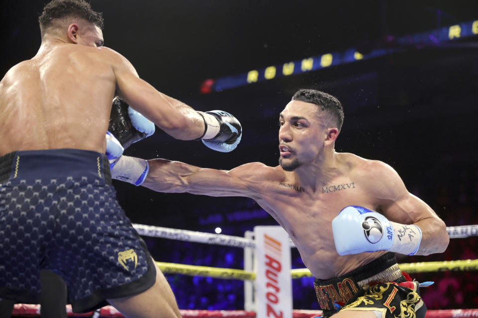 WBO junior welterweight champion Teofimo Lopez, right, lands a body blow to Jamaine Ortiz during a boxing bout Thursday, Feb. 8, 2024, in Las Vegas. Lopez retained his title with a unanimous decision. (Steve Marcus/Las Vegas Sun via AP)