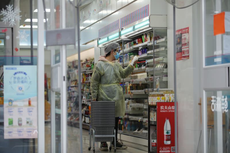 Worker is seen inside a convenience store following an outbreak of the novel coronavirus in Wuhan