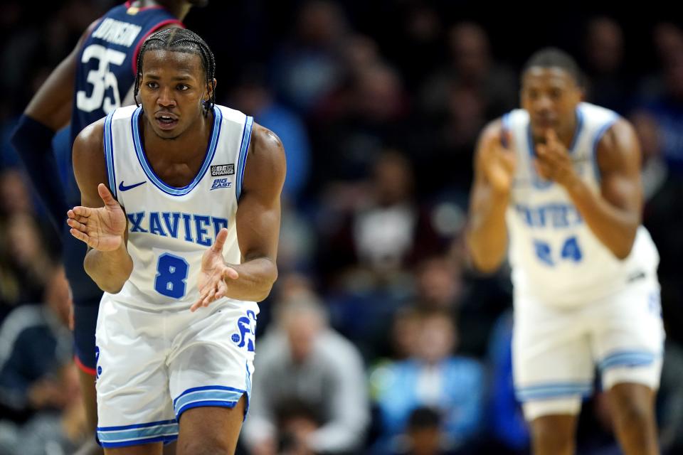 Xavier Musketeers guard Quincy Olivari (8) and Xavier Musketeers forward Saša Ciani (21) clap as they return on defense in the first half of a college basketball game between the Connecticut Huskies and the Xavier Musketeers, Wednesday, Jan. 10, 2024, at Cintas Cetner in Cincinnati.