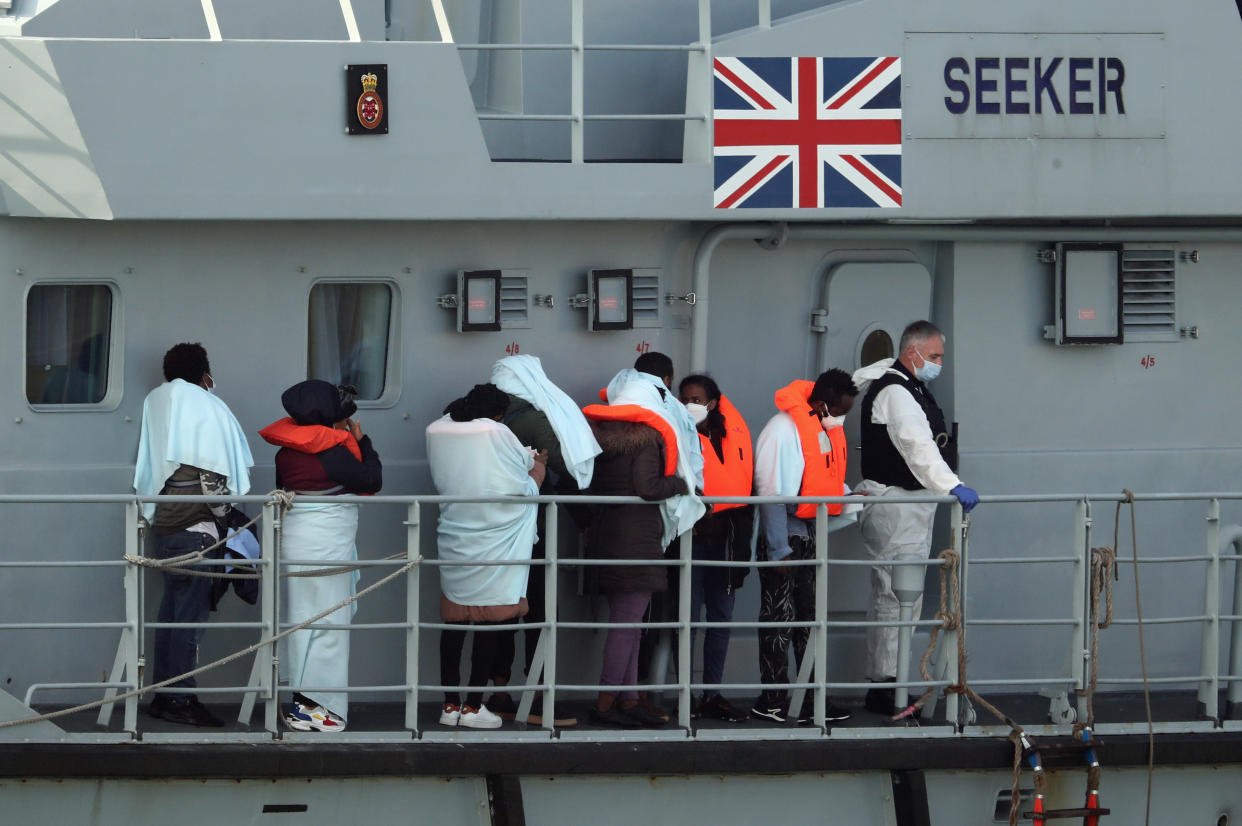 A group of people thought to be migrants on the deck of HMC Seeker, queue to be brought ashore in Dover last year. (PA)