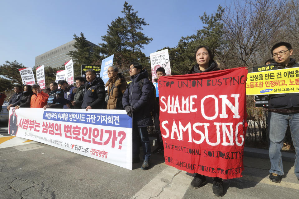 Members of the Korea Confederation of Trade Unions stage a rally demanding arrest of Samsung Electronics Vice Chairman Lee Jae-yong in front of the Seoul High Court in Seoul, South Korea, Friday, Jan. 17, 2020. Lee appeared in court on Friday for his retrial on the corruption allegations that partially fueled the explosive 2016 scandal that spurred massive street protests and sent South Korea's then-president to prison. The sign reads " Arrest, Lee Jae-yong." (AP Photo/Ahn Young-joon)