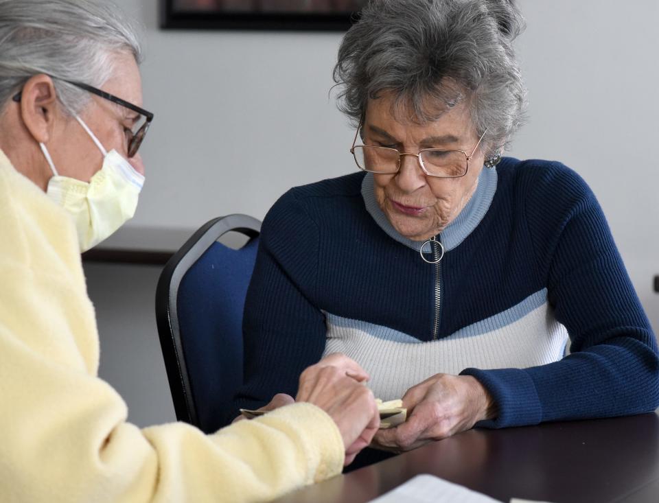 Vonnie Bess (right) reads a 58-year-old pen pal letter to Bev Gerber. The letter was written in French. Bev didn't know what the letter said until she met Vonnie, a native of Canada, at the Monroe Center for Healthy Aging.