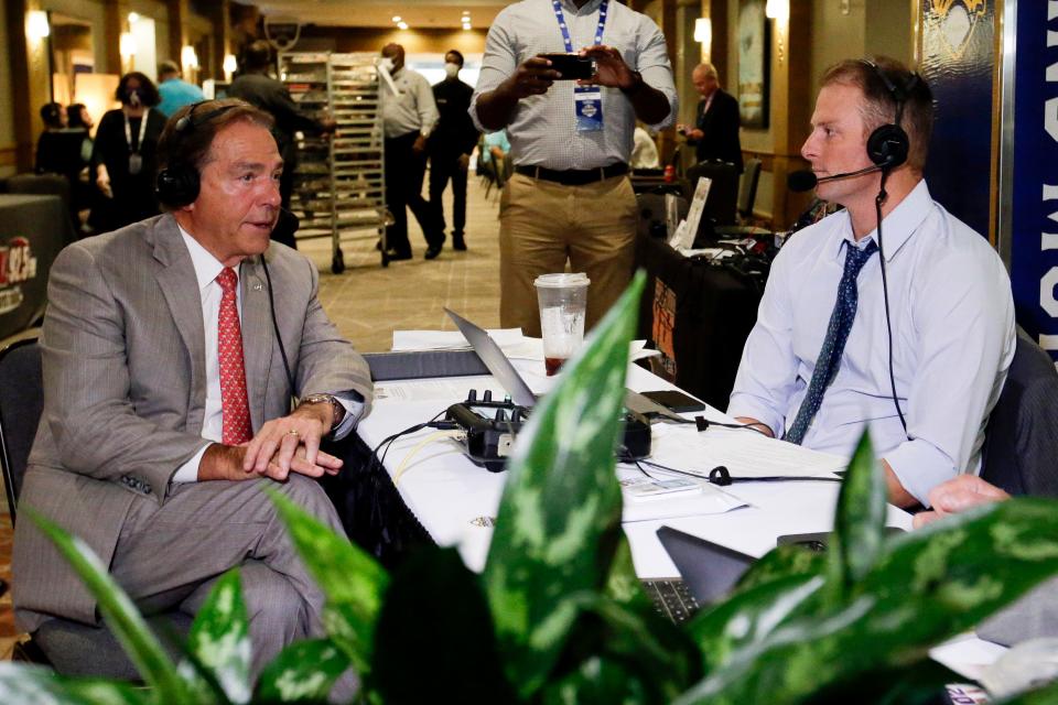 Alabama head coach Nick Saban is interviewed by former Alabama quarterback Greg McElroy during the NCAA college football Southeastern Conference Media Days Wednesday, July 21, 2021, in Hoover, Ala. (AP Photo/Butch Dill)