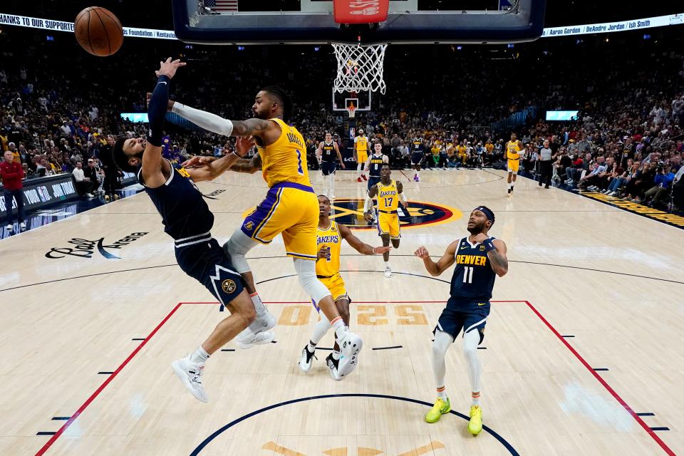 Los Angeles Lakers guard D'Angelo Russell (1) blocks the shot of Denver Nuggets forward Aaron Gordon during the first half of Game 2 of the NBA basketball Western Conference Finals series, Thursday, May 18, 2023, in Denver.